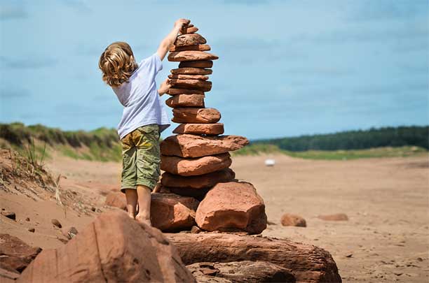 Boy Stacking Stones - Unschooling