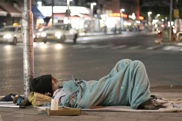 Homeless man sleeping - creating community interdependence